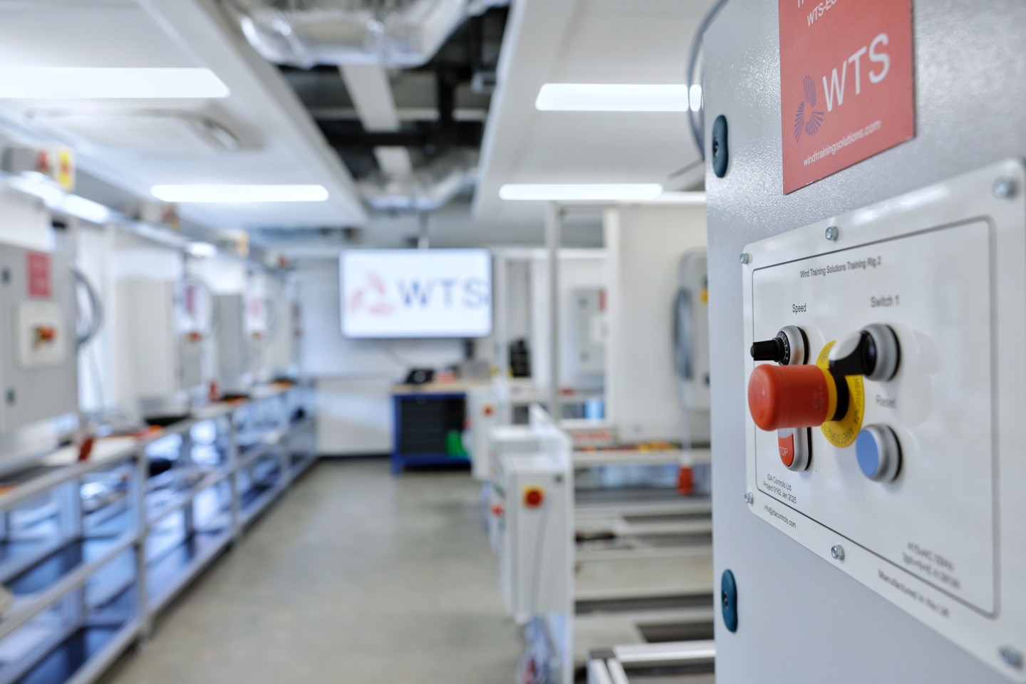 An image of an electrical training rig with an LED television screen in the background.