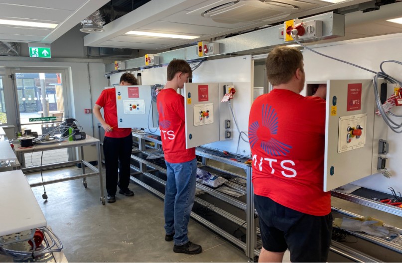 WTS learners working in a classroom on training rigs.