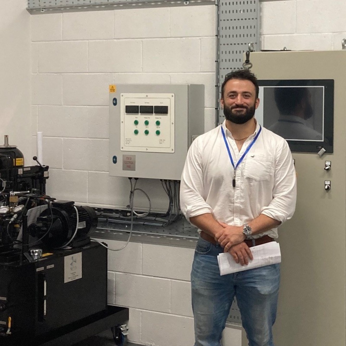 Dominic at Newcastle College in front of equipment designed by WTS